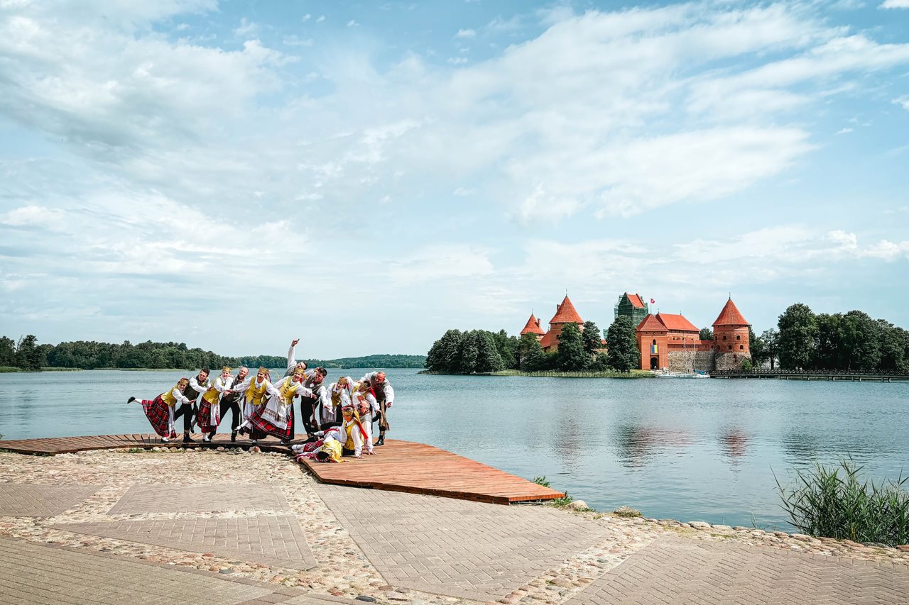 People dressed in traditional costume enjoying an area of the Baltic Republics near the sea.