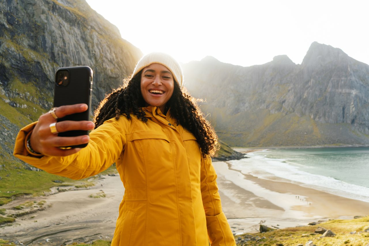 Woman taking a selfie while hiking in the fall.