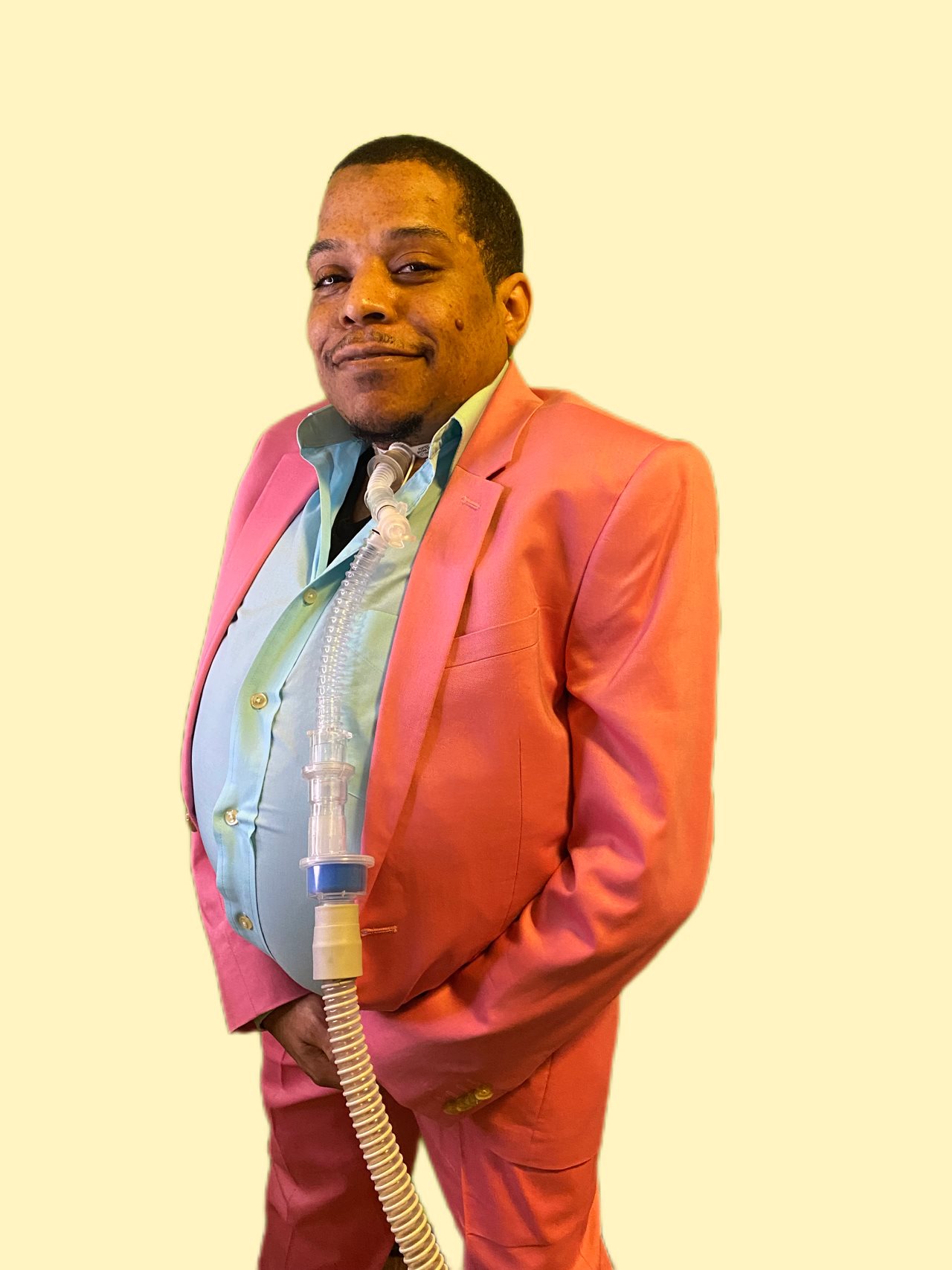 Antwan dressed in salmon colored suit and light blue shirt.