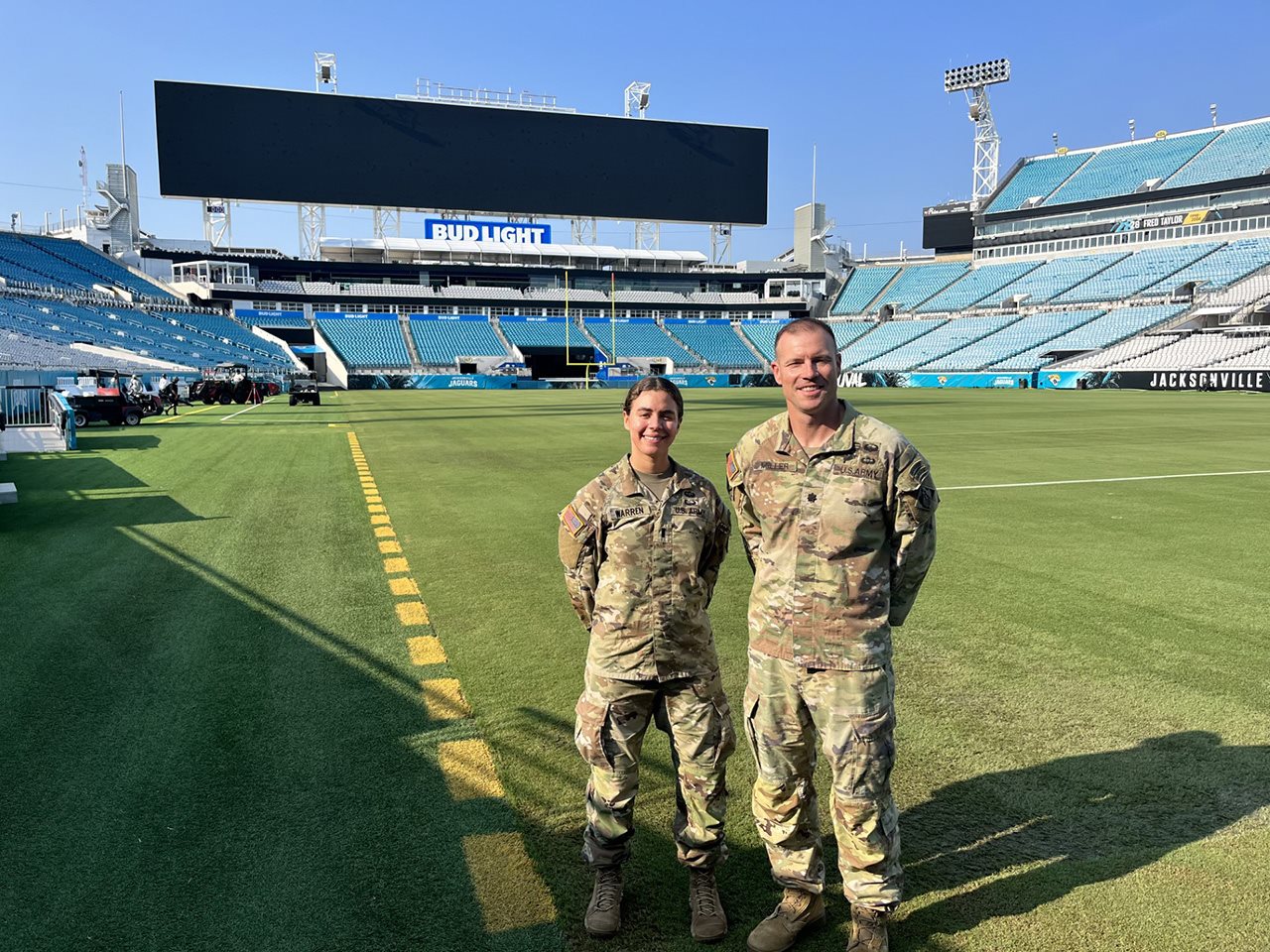 Two U.S. Army soldiers standing on the field in JAX Stadium