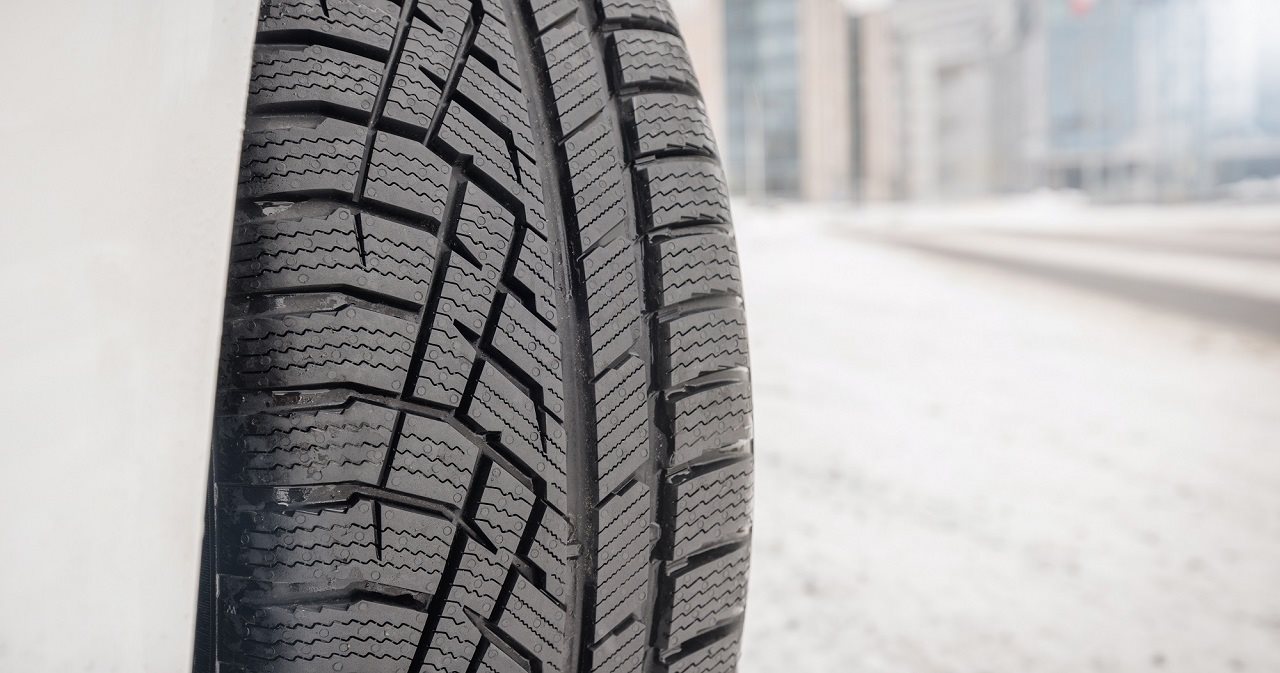 Close up of Nokian tire on a car in the snow.