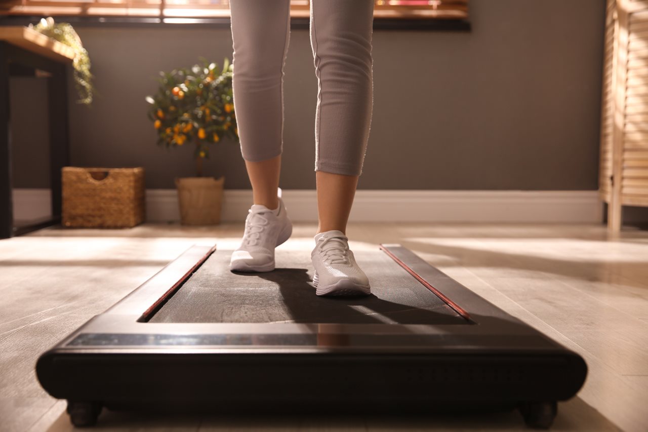 Woman in exercise clothes on a treadmill.