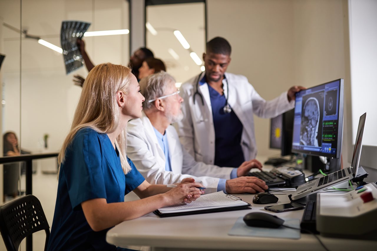 A team of medial professionals reviewing a patient's x-ray.