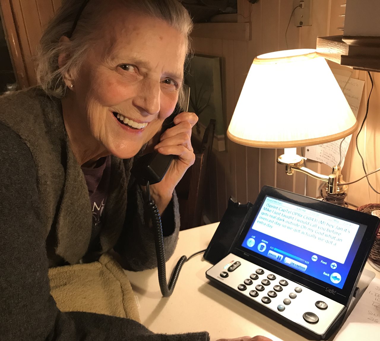 Happy Jan using a special device that makes communication over the phone easier so she can keep in touch with her son.