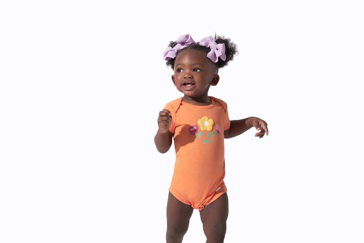 Sweet baby girl in orange onesis.