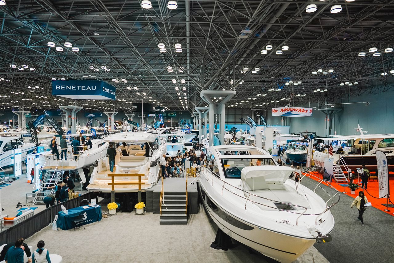 People looking at huge cabin cruisers at a boat show.