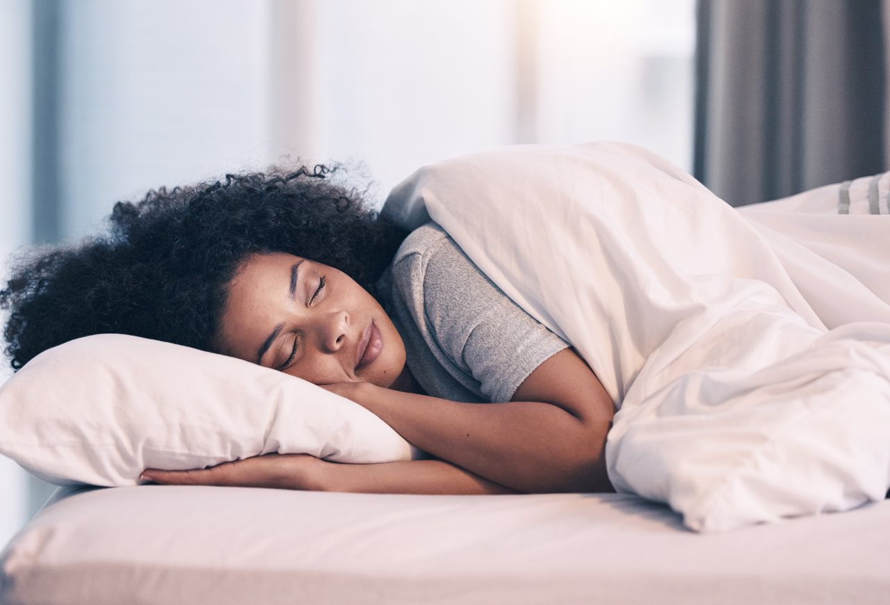 Woman peacefully sleeping in bed.