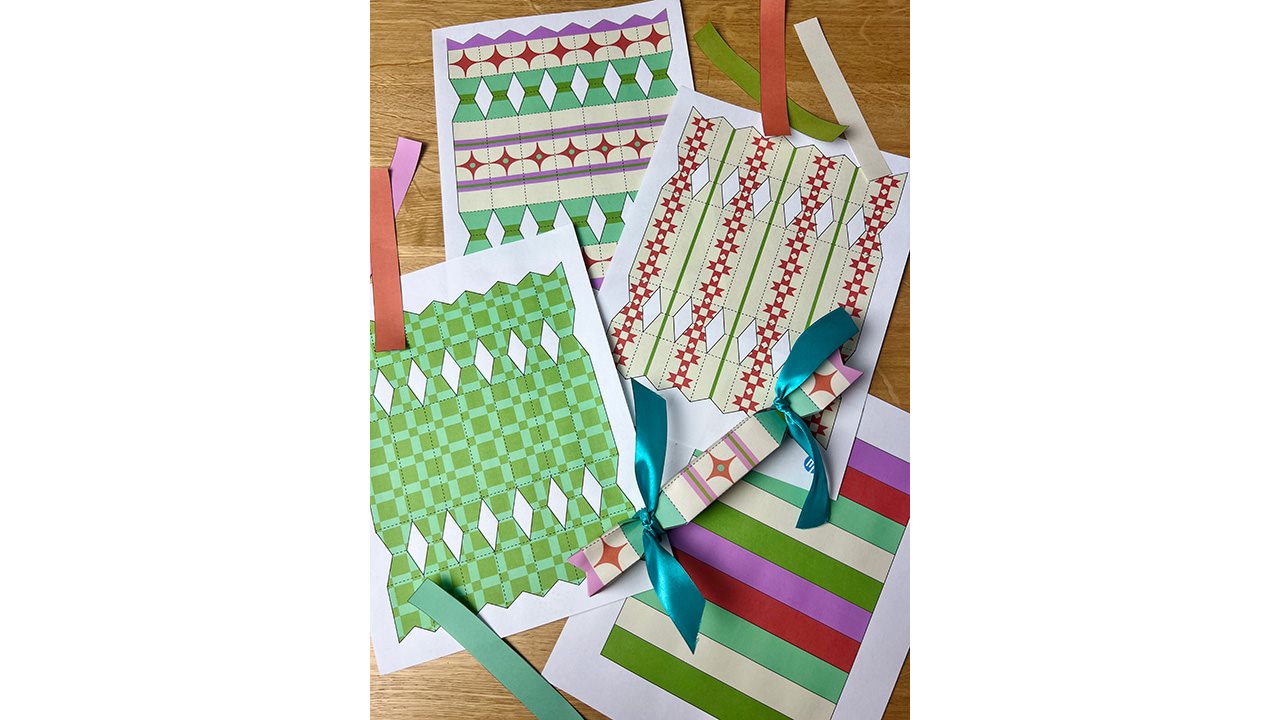 Printable holiday wrappers and ribbon spread out on a table