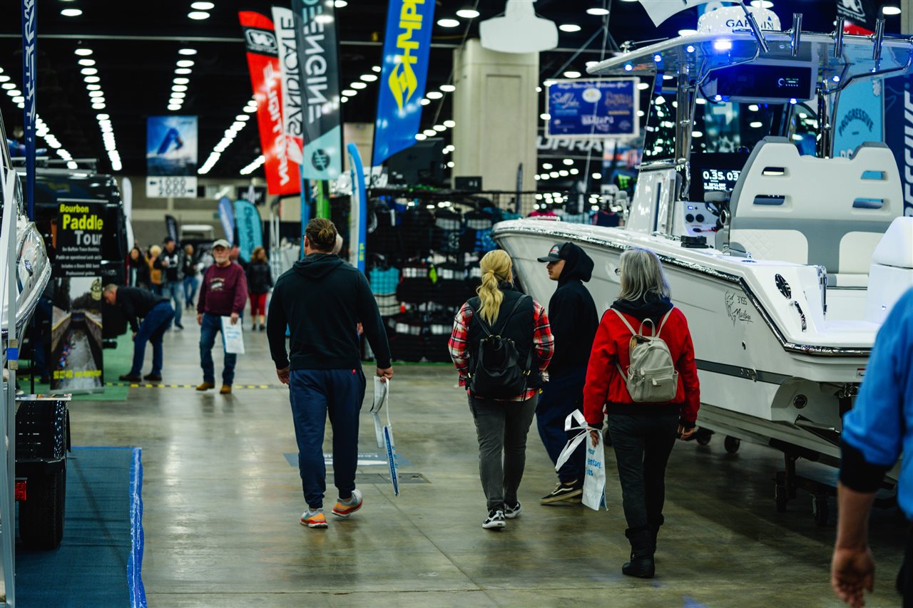 People walking the aisle of a the boat show.