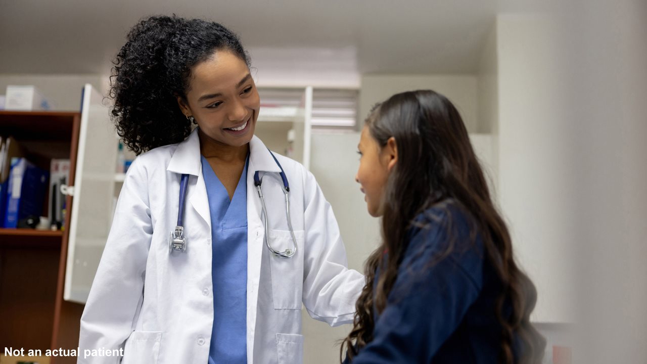 Doctor smiling and talking with female patient