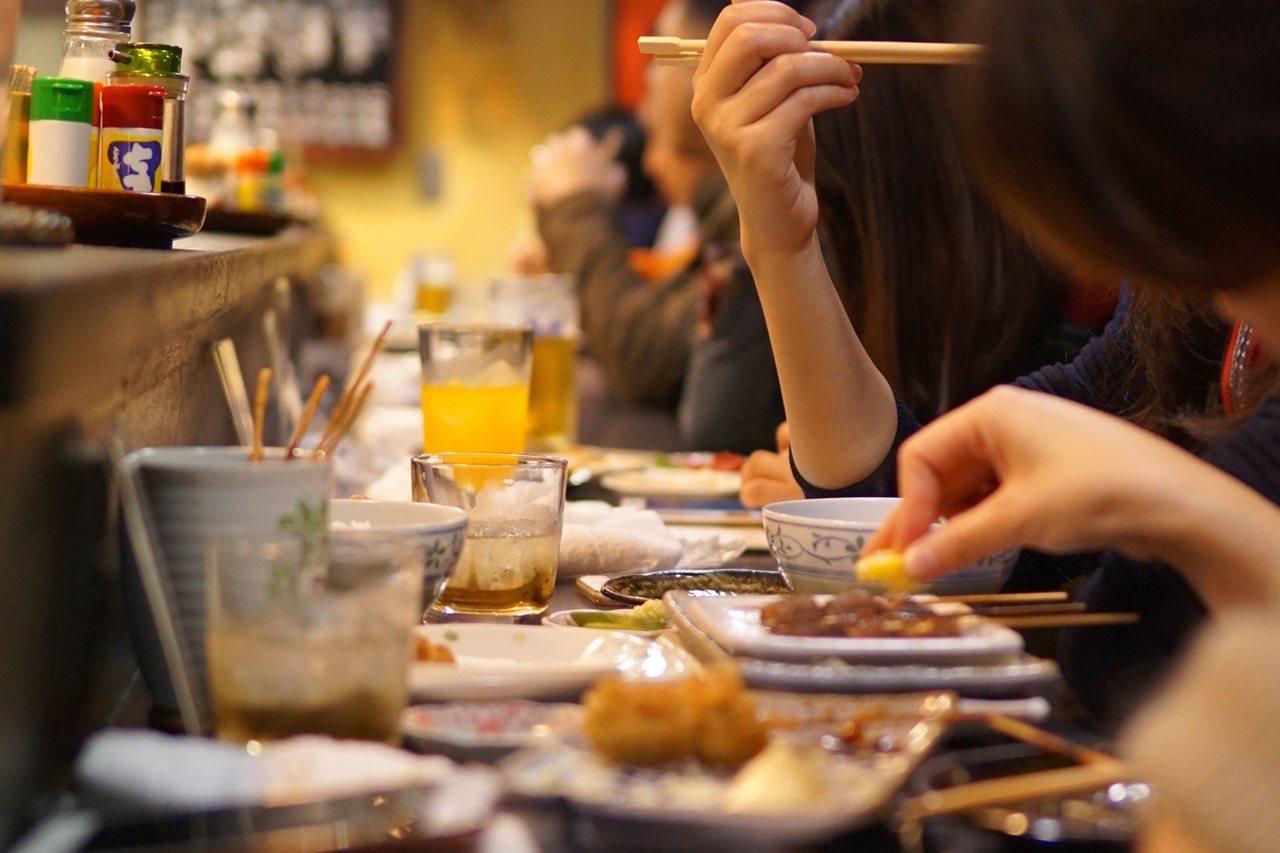 People in a cafe enjoying traditional Japanese Cuisine.