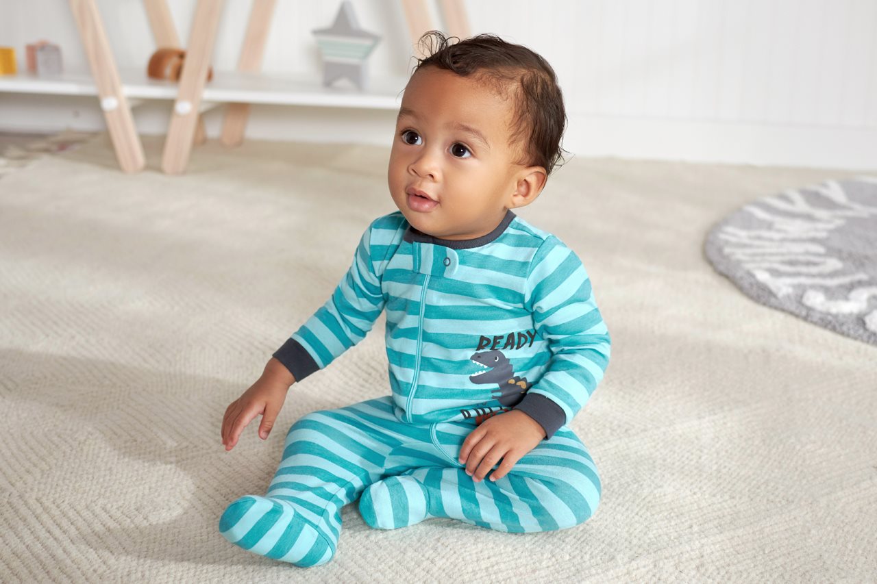 Cute baby boy in teal striped pajamas