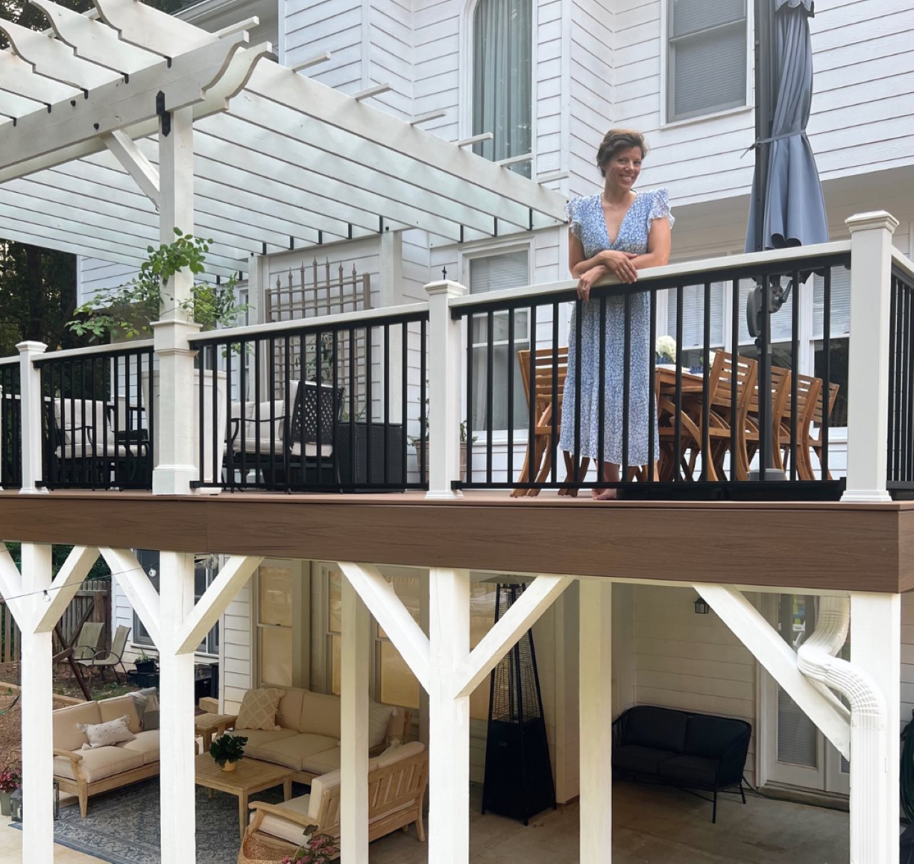 Woman leaning on the railing of an upscale deck.